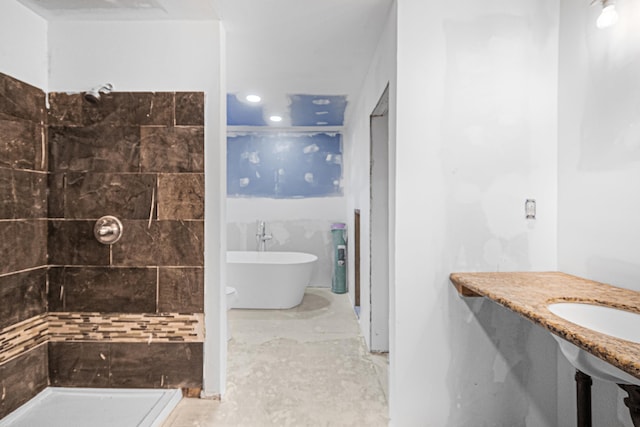 bathroom featuring a freestanding bath and tiled shower