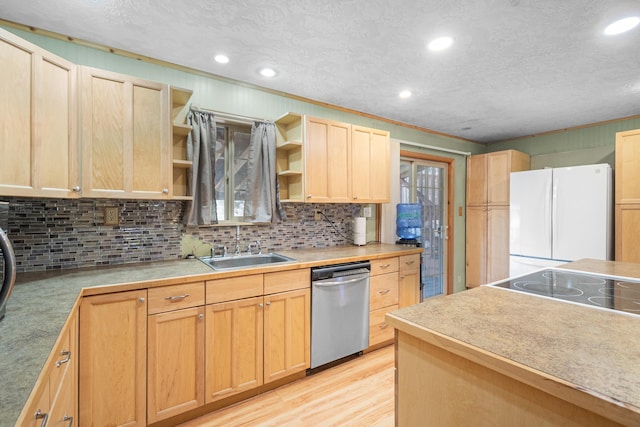 kitchen with freestanding refrigerator, light brown cabinetry, stainless steel dishwasher, open shelves, and a sink