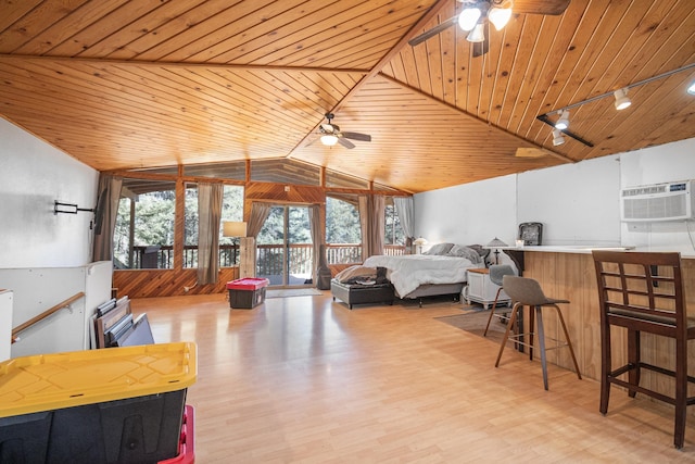 bedroom with lofted ceiling, wood ceiling, an AC wall unit, track lighting, and wood finished floors