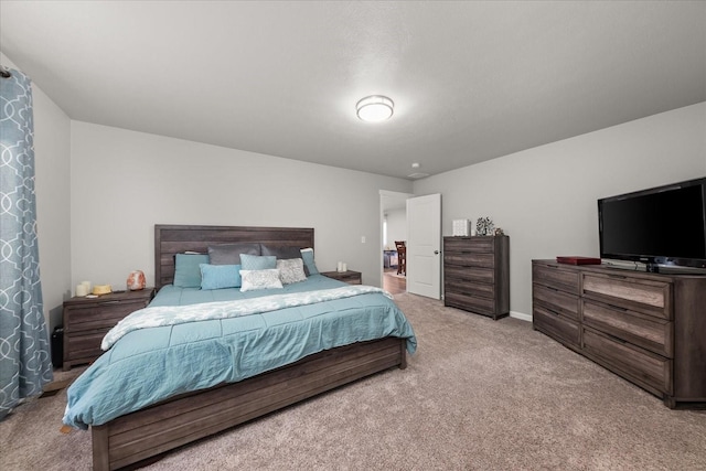 bedroom with carpet floors and baseboards