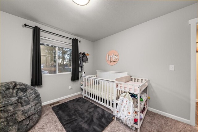 carpeted bedroom featuring visible vents and baseboards