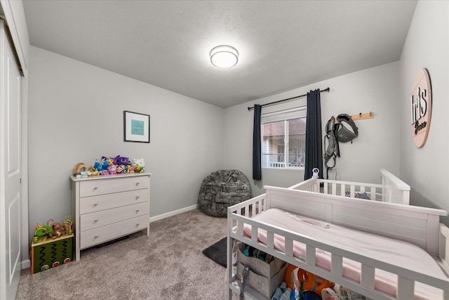 bedroom featuring carpet floors, a textured ceiling, and baseboards