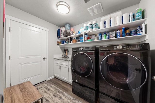 laundry area featuring independent washer and dryer and wood finished floors