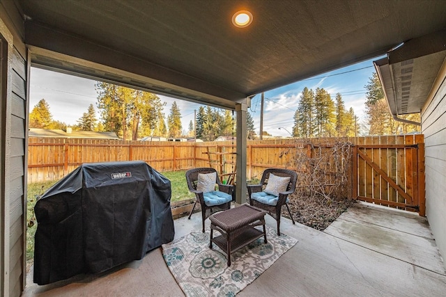 view of patio / terrace with a fenced backyard, a gate, and grilling area