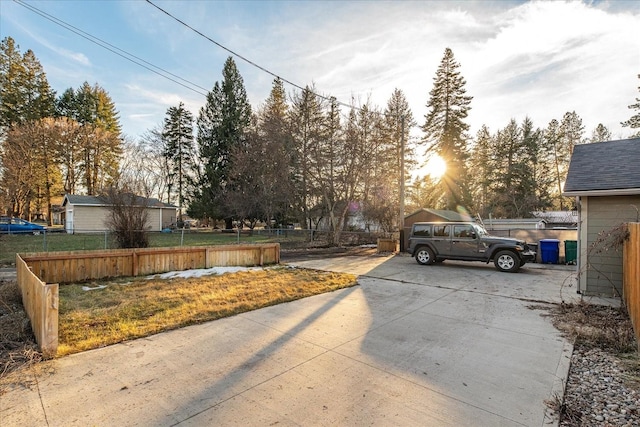 view of road featuring concrete driveway