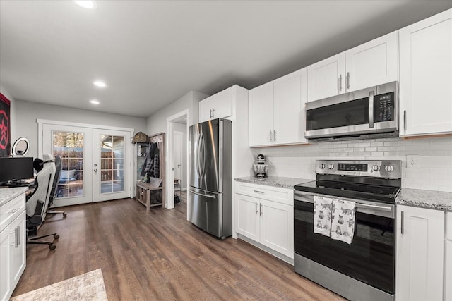 kitchen featuring french doors, appliances with stainless steel finishes, dark wood finished floors, and white cabinets