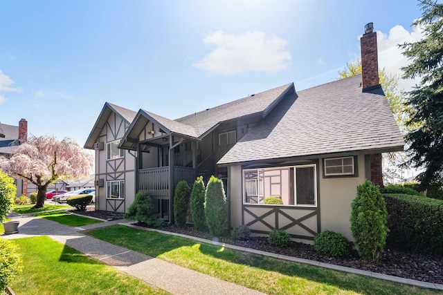 102 E Weile Ave # 3, Spokane, WA 99208 - english style home with a front lawn, a chimney, stucco siding, and roof with shingles