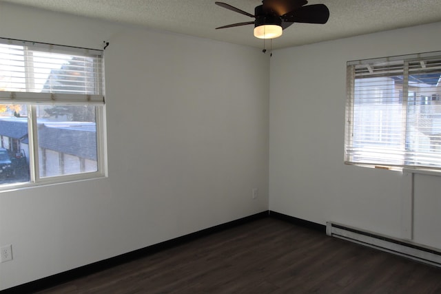 unfurnished room featuring a baseboard heating unit, a textured ceiling, and plenty of natural light