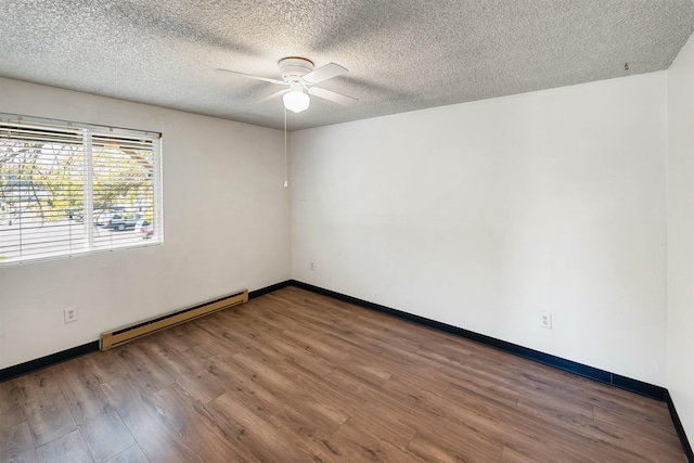 102 E Weile Ave # 3, Spokane, WA 99208 - unfurnished room featuring baseboards, wood finished floors, a ceiling fan, and a baseboard radiator