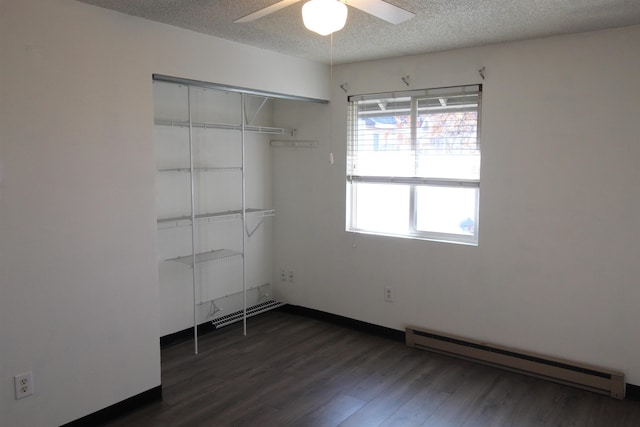 interior space featuring a baseboard radiator, visible vents, dark wood-type flooring, ceiling fan, and a textured ceiling