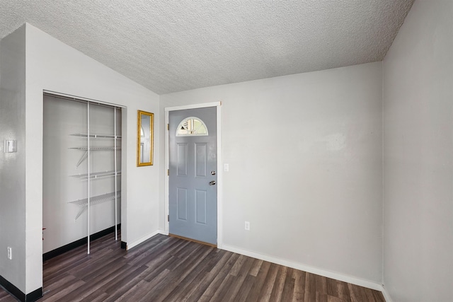 102 E Weile Ave # 3, Spokane, WA 99208 - foyer entrance with a textured ceiling, dark wood-style floors, and baseboards