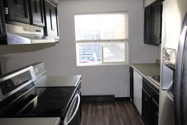 kitchen featuring under cabinet range hood, dark wood-type flooring, light countertops, appliances with stainless steel finishes, and dark cabinetry