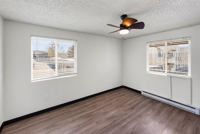 102 E Weile Ave # 3, Spokane, WA 99208 - empty room featuring wood finished floors, plenty of natural light, a textured ceiling, and a baseboard radiator