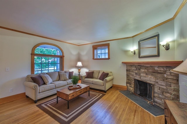2508 S Grand Blvd, Spokane, WA 99203 - living area with crown molding, wood finished floors, a stone fireplace, and baseboards