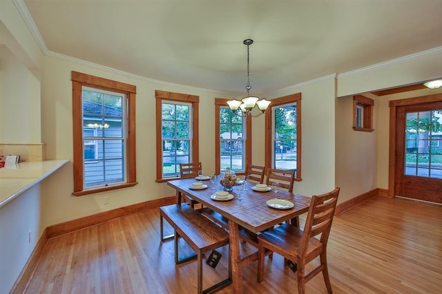 2508 S Grand Blvd, Spokane, WA 99203 - dining room featuring a chandelier, light wood finished floors, healthy amount of natural light, baseboards, and crown molding