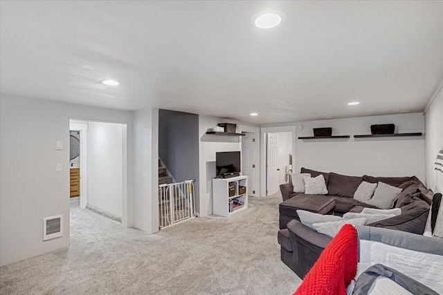 carpeted living area featuring stairway, visible vents, and recessed lighting