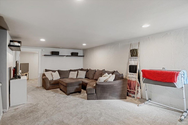 living area with a textured wall, carpet floors, and recessed lighting