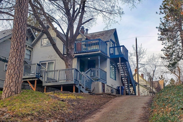 rear view of property with stairway