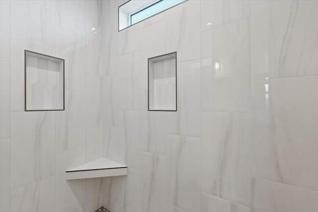 full bath featuring a tile shower