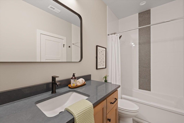 bathroom with toilet, shower / tub combo, visible vents, and vanity