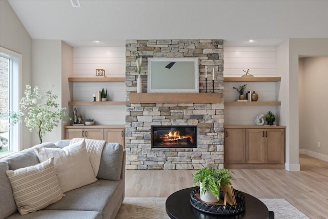 living area featuring recessed lighting, a fireplace, baseboards, vaulted ceiling, and light wood-type flooring