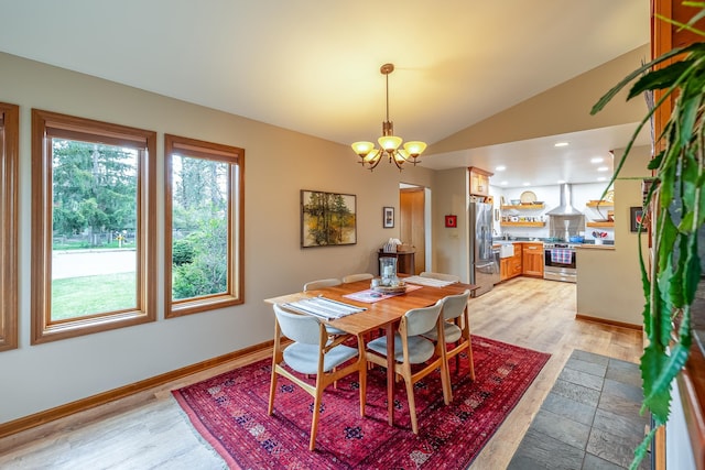 dining space featuring a chandelier, recessed lighting, baseboards, vaulted ceiling, and light wood finished floors