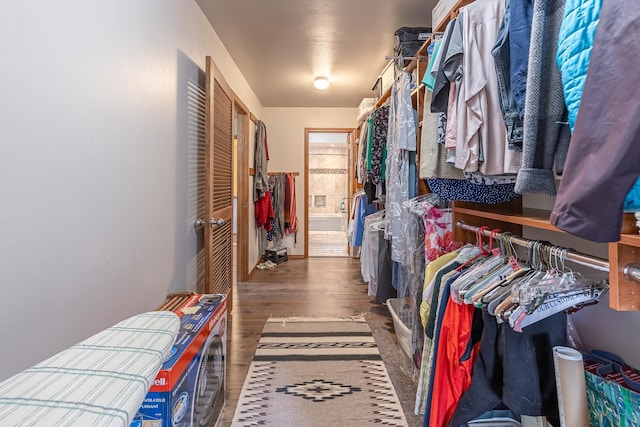 walk in closet with wood finished floors