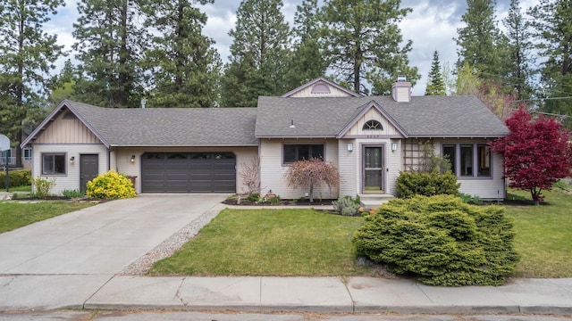 view of front of house with a garage, a shingled roof, a chimney, and a front yard