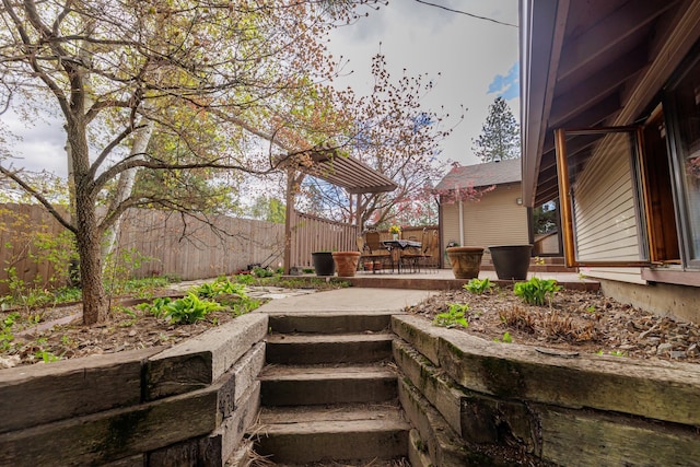 view of community featuring a patio and fence