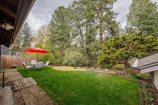 view of yard with fence and a patio