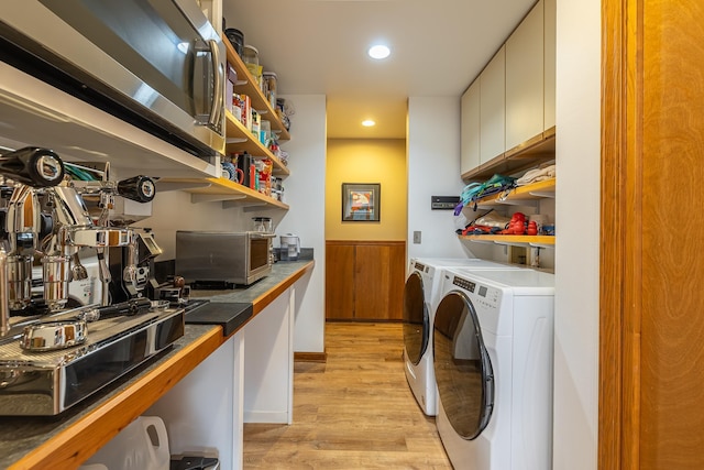 clothes washing area featuring wainscoting, light wood-style flooring, washing machine and clothes dryer, and recessed lighting