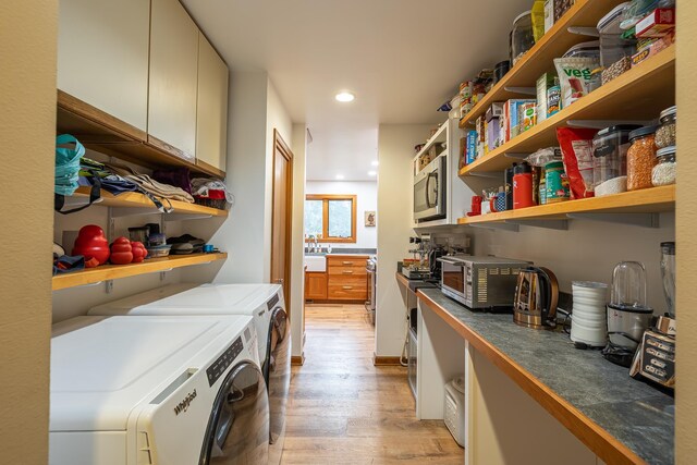 laundry area with recessed lighting, a toaster, laundry area, washer and dryer, and light wood finished floors