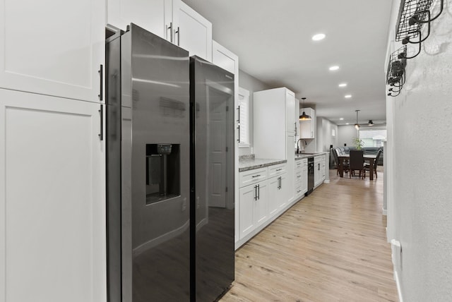 kitchen featuring light wood finished floors, white cabinets, stainless steel fridge with ice dispenser, a sink, and recessed lighting