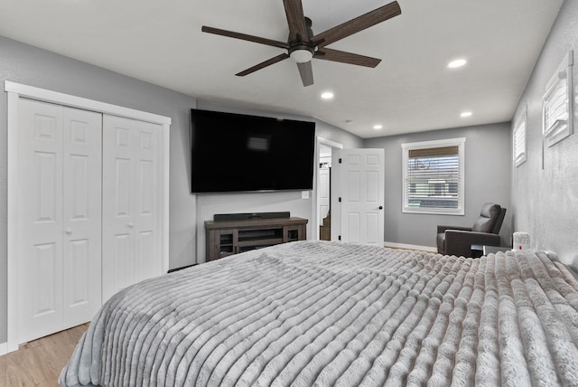 bedroom featuring ceiling fan, light wood-style flooring, recessed lighting, baseboards, and a closet