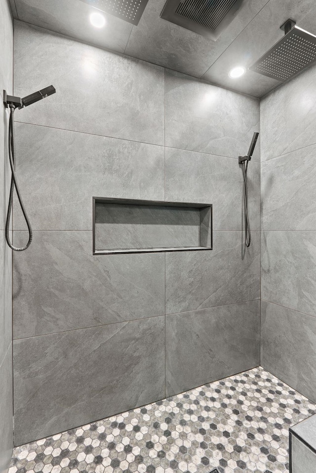 full bathroom with tiled shower, visible vents, and recessed lighting