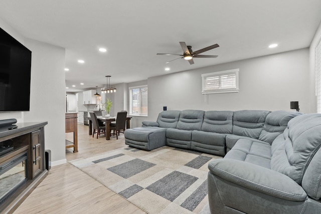 living area with light wood-style floors, recessed lighting, and a healthy amount of sunlight