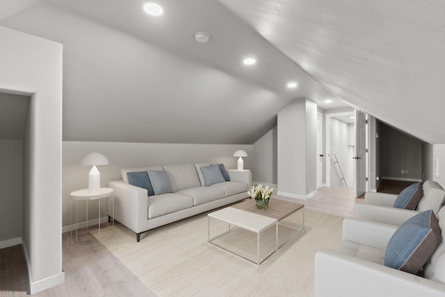 living area featuring baseboards, vaulted ceiling, wood finished floors, and recessed lighting