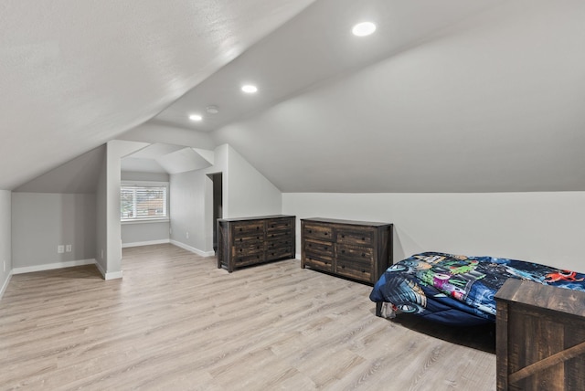 bedroom featuring baseboards, vaulted ceiling, wood finished floors, and recessed lighting