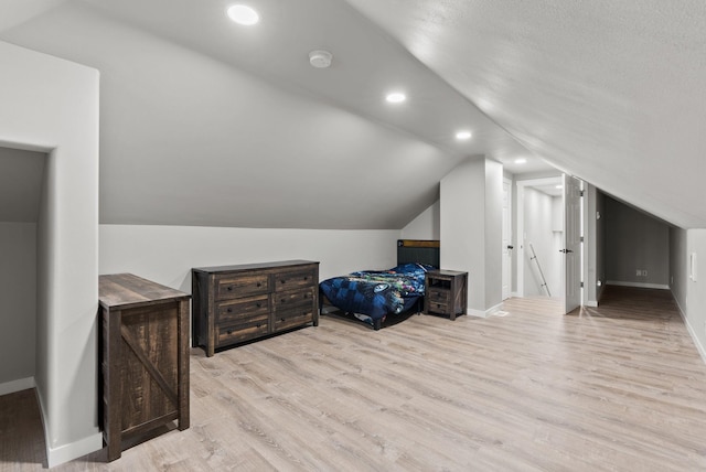 additional living space featuring lofted ceiling, recessed lighting, baseboards, and wood finished floors