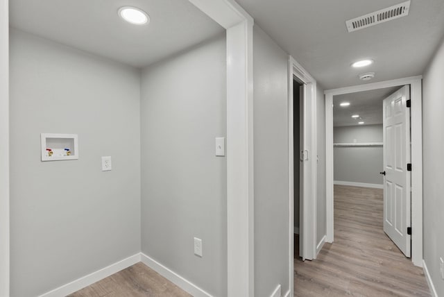 corridor featuring baseboards, recessed lighting, visible vents, and light wood-style floors