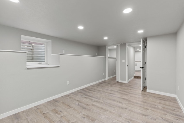 below grade area featuring light wood-type flooring, baseboards, and recessed lighting