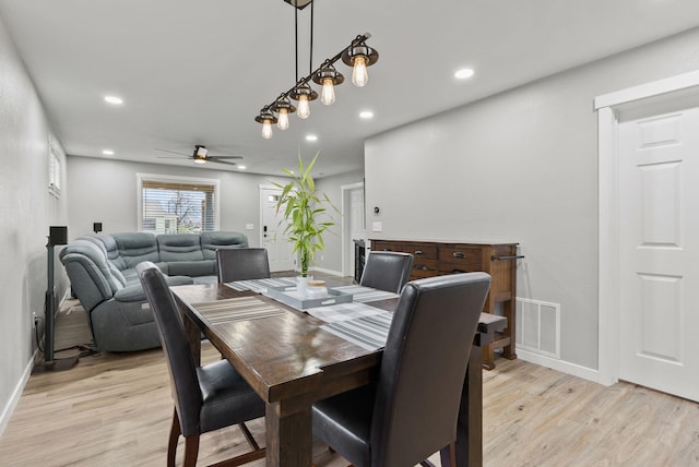 dining space featuring light wood-style floors, baseboards, visible vents, and recessed lighting