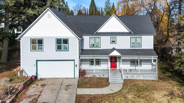 traditional home featuring an attached garage, a shingled roof, a porch, and concrete driveway