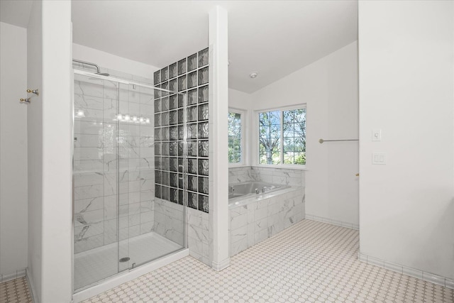 full bathroom featuring a stall shower, vaulted ceiling, baseboards, and a bath