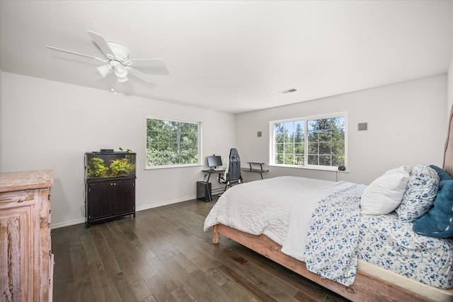 bedroom featuring ceiling fan, dark wood finished floors, visible vents, and baseboards