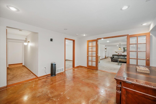 empty room with concrete flooring, recessed lighting, visible vents, baseboards, and french doors