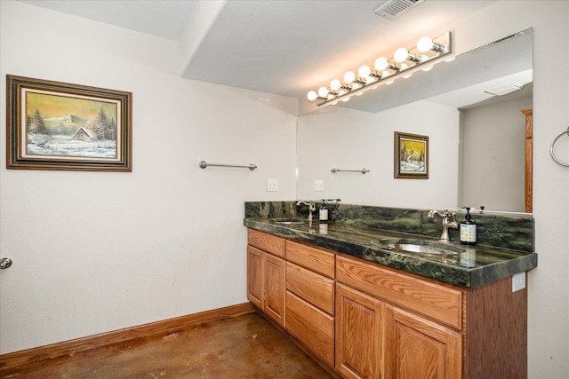 bathroom featuring concrete floors, a sink, visible vents, and baseboards