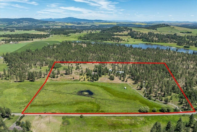 drone / aerial view featuring a water and mountain view