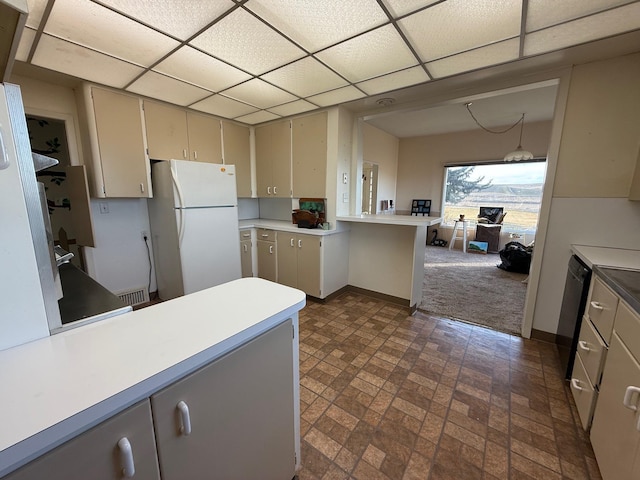 kitchen featuring a paneled ceiling, gray cabinetry, and freestanding refrigerator