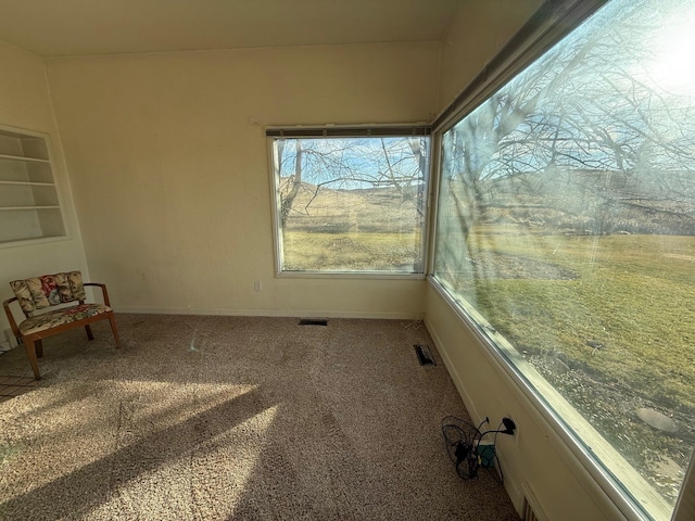 unfurnished sunroom with visible vents